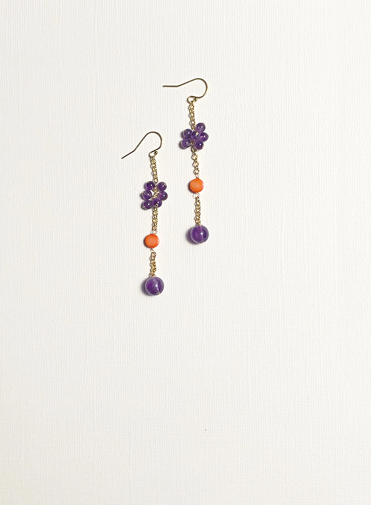 Gold chain drop earrings featuring amethyst and orange sea bamboo coral.