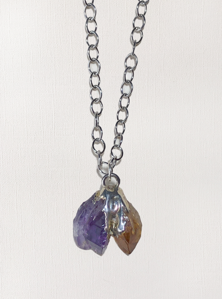 Pendant featuring natural amethyst and citrine set in silver and suspended on a sterling silver chain.